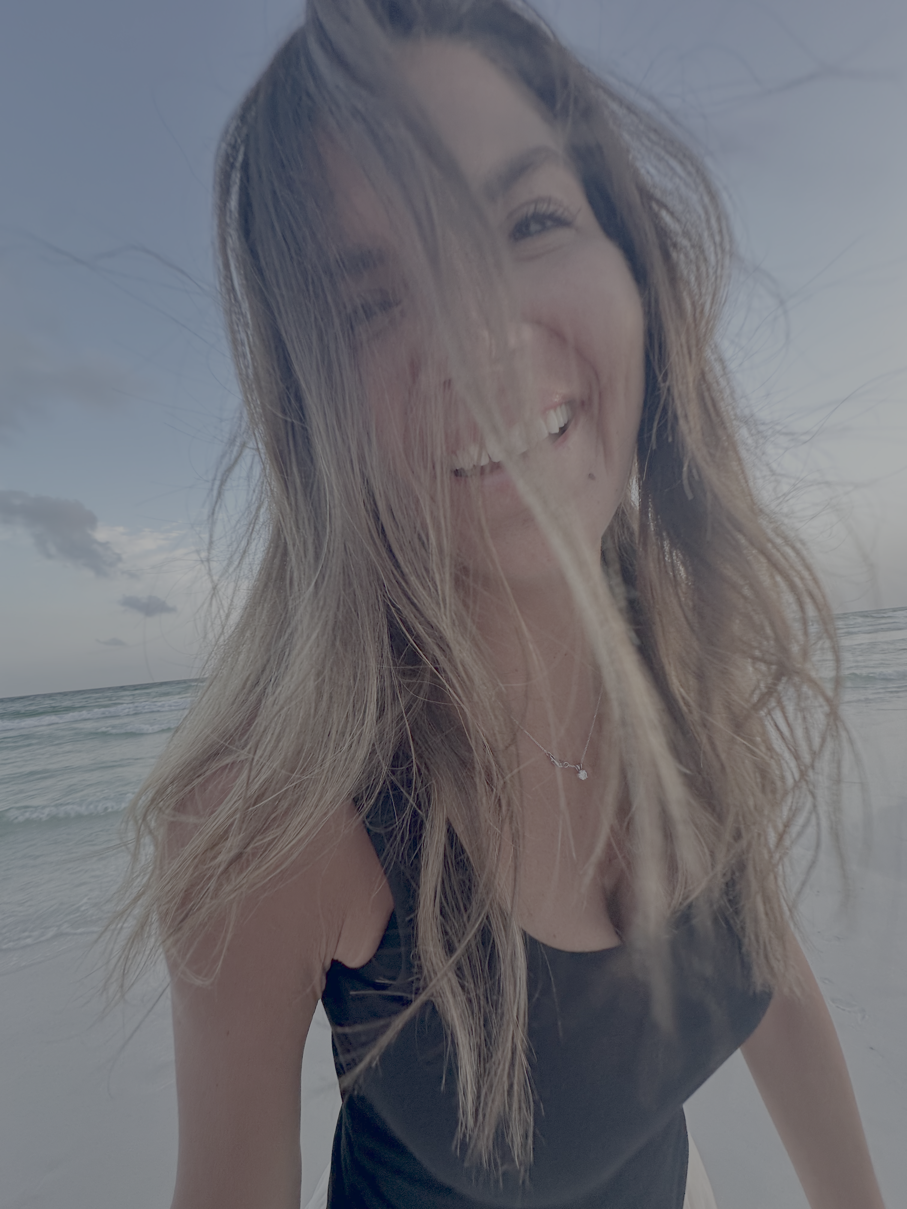 Folded t-shirts with cartoon designs. Animated flower, pizza cloud rainbow, and smiling alien logos laid in a stack on a t...